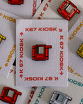 Značka K67 - emajlirana kovinska broška